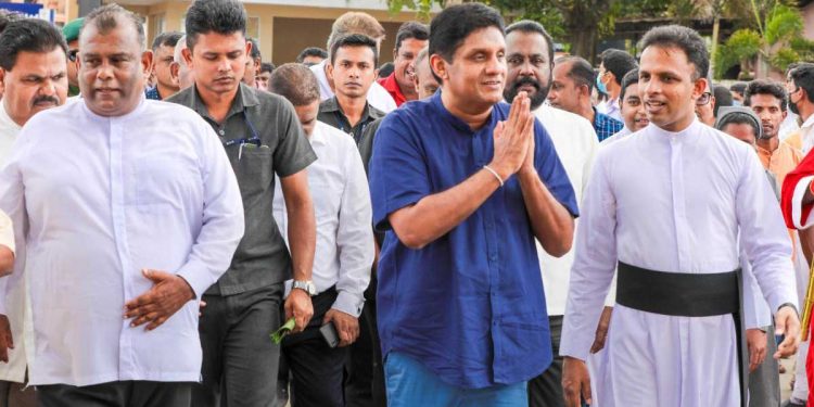 ආණ්ඩුව නෑ බෑ කියද්දි විපක්ෂයේ ඉදන් සජිත් දිගටම වැඩ කරගෙන යයි! මෙන්න හලාවත ඉස්කෝලෙකට බස් එකකුත් ගිහිල්ලා! (VIDEO & PHOTOS)