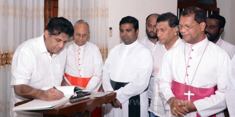 හැමෝම හොයන්න බැරි මහමොළකාරයා හොයනවා! පාස්කු ප්‍රහාරයට පස්සේ සජිත් ප්‍රේමදාස මාස දෙකෙන් මොනවද කළේ? කොච්චිකඩේ පල්ලියට වරායෙන් ඉඩමකුත් අරන් දුන්නා! හැම අඟහරුවාදාම බිෂොප් හවුස් එකේ සාකච්ඡාවට වාඩිවුණා! වහලේ දුර්ලභ වීදුරු වතිකානයෙන් ගෙන්නුවා! වින්දිතයන් සියලු දෙනාට ගෙවල් හදලා දුන්නා! දේවස්ථාන 3ම රජයේ අරමුදලින් හැදුවා! Sri Lanka Latest News